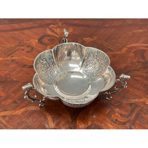 8165 - A silver footed sugar basket, melon fluted with scrolled foliage, anamorphic supports, marks rubbed,... 