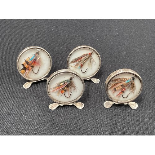 8279 - Four silver menu/name card holders, the circular glass front panels each containing a fishing fly, B... 