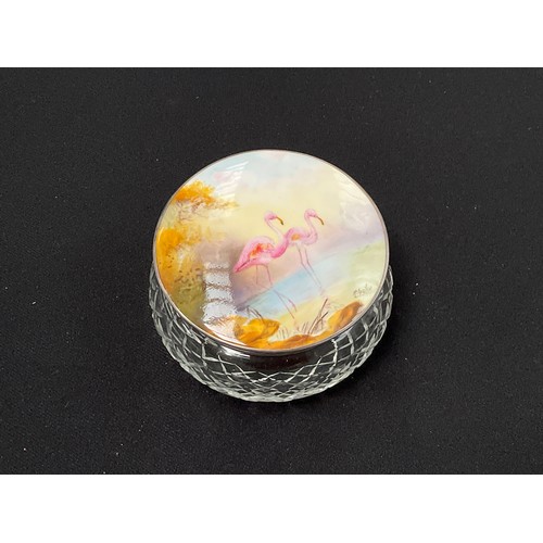 8282 - A cut glass powder jar with a silver framed Royal Worcester lid depicting flamingos signed R.Austin,... 