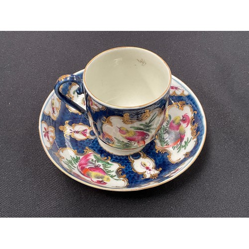 8289 - A Worcester coffee cup and saucer decorated in exotic birds, enriched in gilt against a blue mottled... 