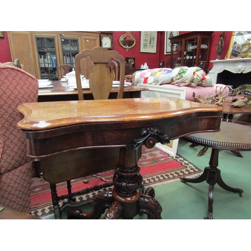 66 - An early Victorian circa 1850 burr walnut serpentine front hinged top card table on a carved and tur... 