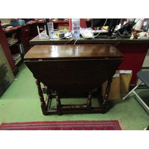 69 - A circa 1800 oval top drop-leaf table with end drawer on turned supports joined by stretchers, appro... 