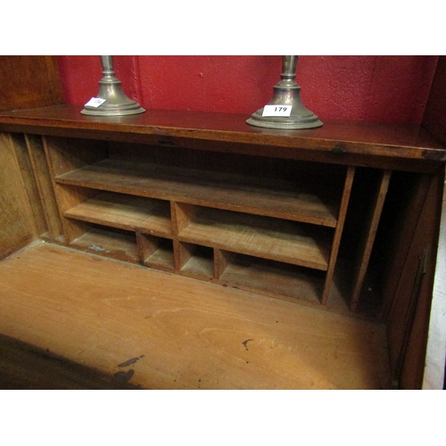 77 - An Arts & Crafts walnut bureau the fall front with key and fitted shelf interior over two drawers an... 