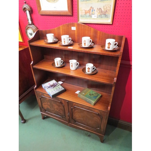 83 - A Bevan Funnell Georgian style flame mahogany waterfall bookshelf over a two door cupboard with work... 