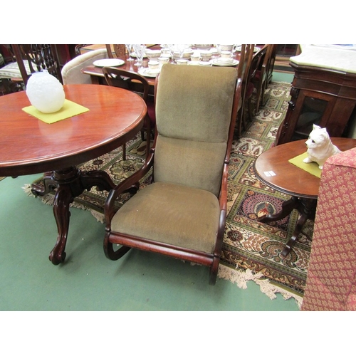 113 - An early Victorian mahogany rocking chair the raised back rest with scroll top over open arms with c... 