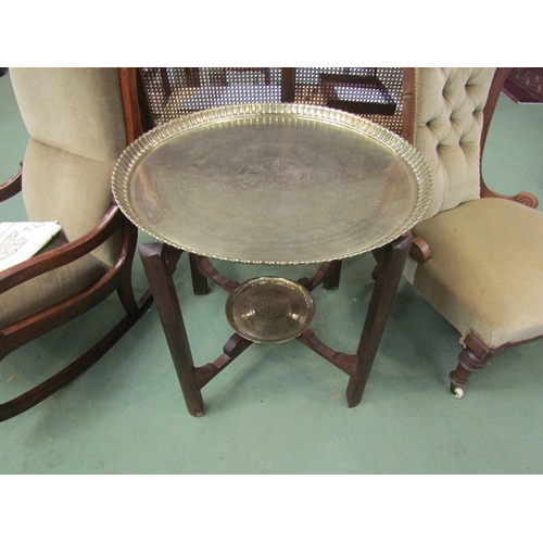 110 - An Islamic folding table with script and brass animal design circular tray top, with tray to underti... 