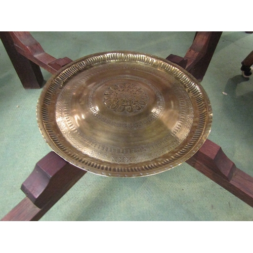 110 - An Islamic folding table with script and brass animal design circular tray top, with tray to underti... 