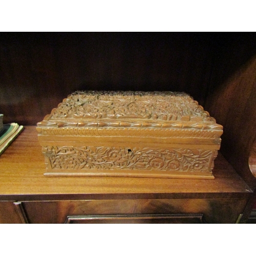 86 - A sewing/jewellery box with Eastern heavily carved floral design.