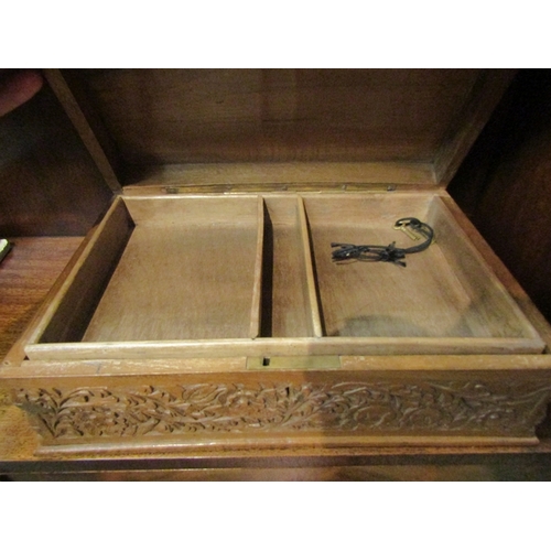 86 - A sewing/jewellery box with Eastern heavily carved floral design.