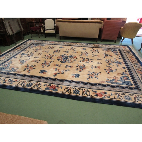 453 - A large hand knotted wool Chinese rug in cream and blue tones, scenes of flora and fauna, tasselled ... 