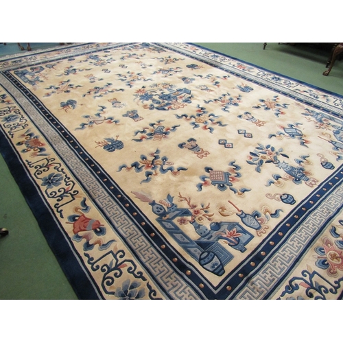 453 - A large hand knotted wool Chinese rug in cream and blue tones, scenes of flora and fauna, tasselled ... 