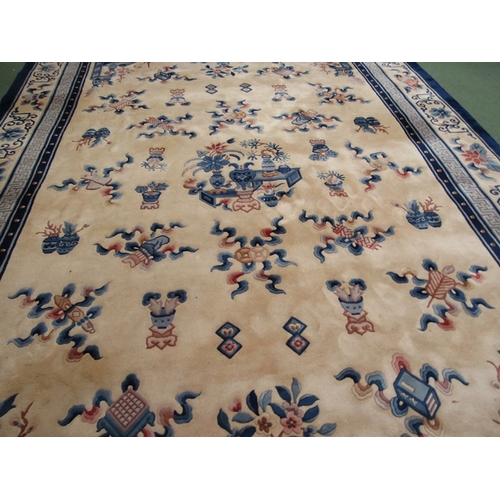 453 - A large hand knotted wool Chinese rug in cream and blue tones, scenes of flora and fauna, tasselled ... 