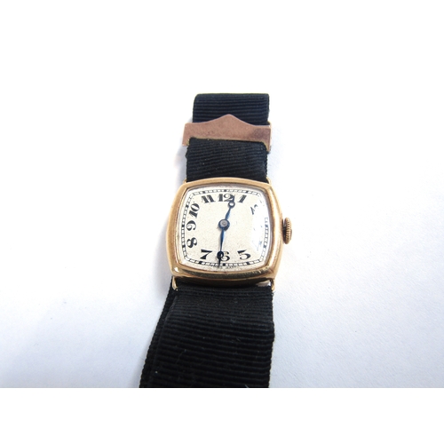 8091 - An 18ct gold cased lady's wristwatch, rounded square face, black ribbon strap, and a gold fob watch ... 