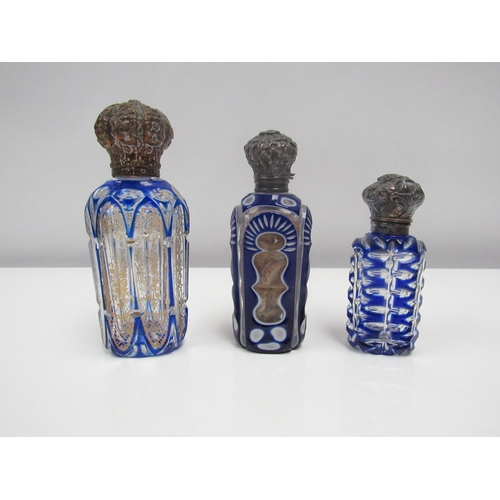 8182 - Three glass scent bottles, one decorated in gilt