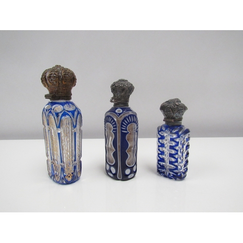 8182 - Three glass scent bottles, one decorated in gilt