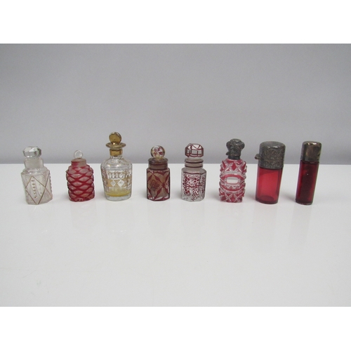 8188 - Eight glass scent bottles, some cut glass Cranberry, and silver top examples