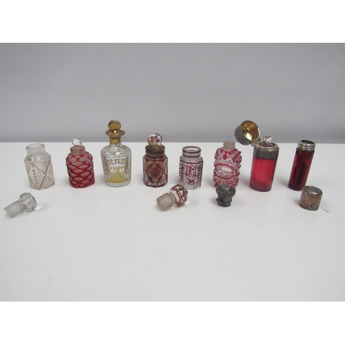 8188 - Eight glass scent bottles, some cut glass Cranberry, and silver top examples