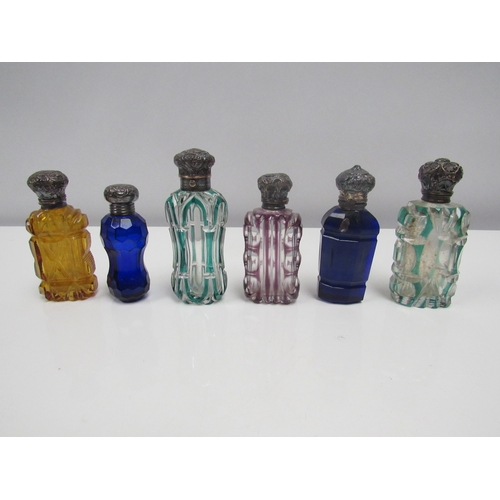 8189 - Six coloured cut glass scent bottles, one with hallmarked silver lid, another with Swan design to li... 