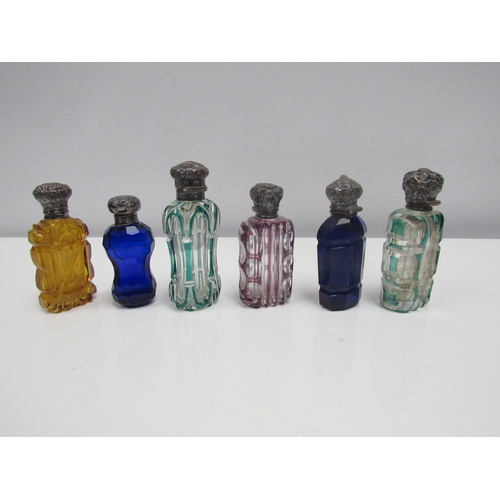 8189 - Six coloured cut glass scent bottles, one with hallmarked silver lid, another with Swan design to li... 