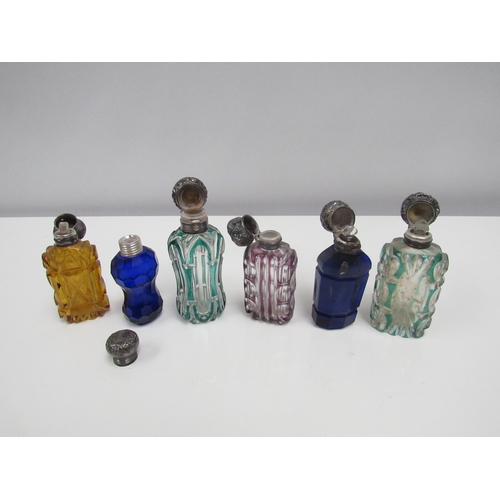 8189 - Six coloured cut glass scent bottles, one with hallmarked silver lid, another with Swan design to li... 