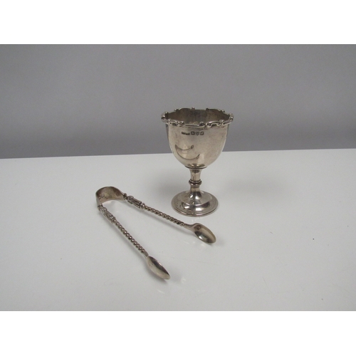 8218 - A Charles Perry & Co. silver egg cup and pair of silver sugar tongs. 79g.  (2)