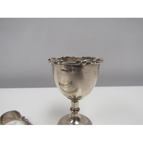 8218 - A Charles Perry & Co. silver egg cup and pair of silver sugar tongs. 79g.  (2)