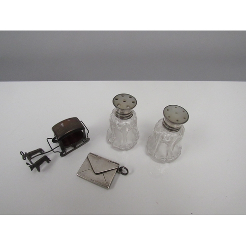 8234 - A silver envelope stamp case, pepper pots and sledge (3)