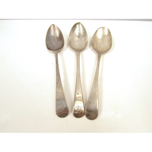 8242 - Three silver Georgian serving spoons, London 1794, 1790 & 1802, monogrammed handles, 183g