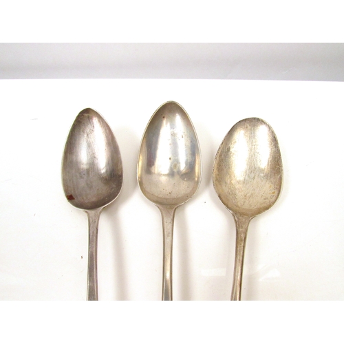 8242 - Three silver Georgian serving spoons, London 1794, 1790 & 1802, monogrammed handles, 183g