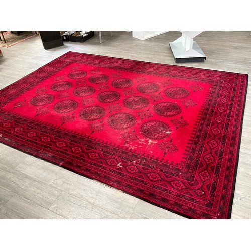 8605 - An Afghan wool carpet, three rows of central guls, multiple borders, 366cm x 275cm   (E) £100-200