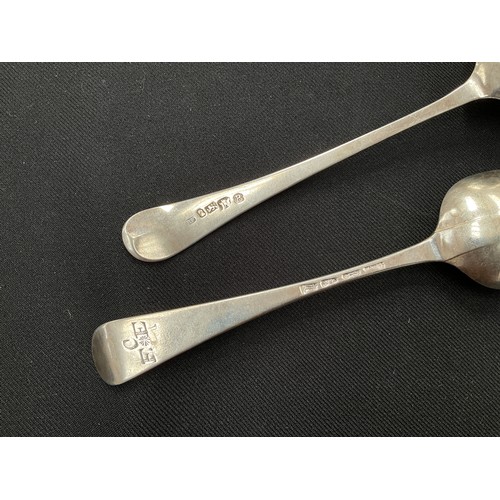 8223 - Two Georgian silver serving spoons, one with bright cut detail and monogrammed handles, 108g