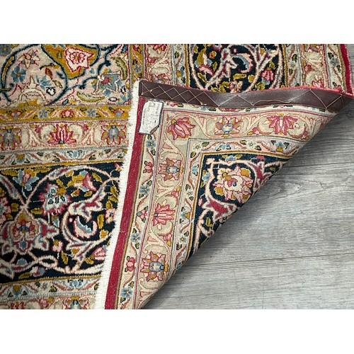 8606 - A Middle Eastern carpet, the central red ground with all over foliage with central gul, within a mul... 