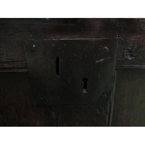 5 - A 17th Century pegged oak coffer the split hinge top over a four panel base on stile feet, 108cm wid... 