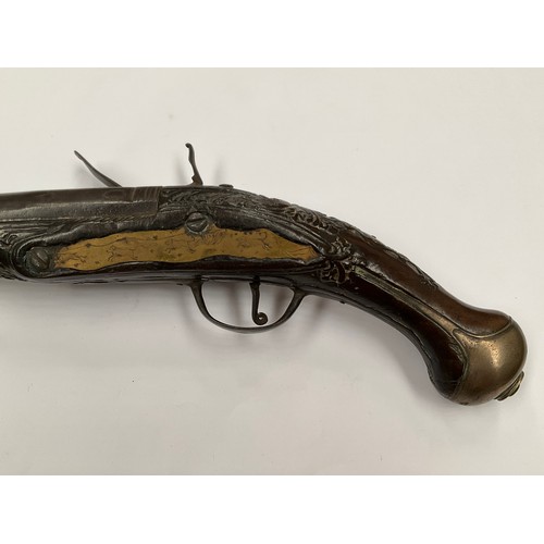 5326 - A late 18th Century flintlock pistol with all over scrolled foliate carving, part of mechanism missi... 