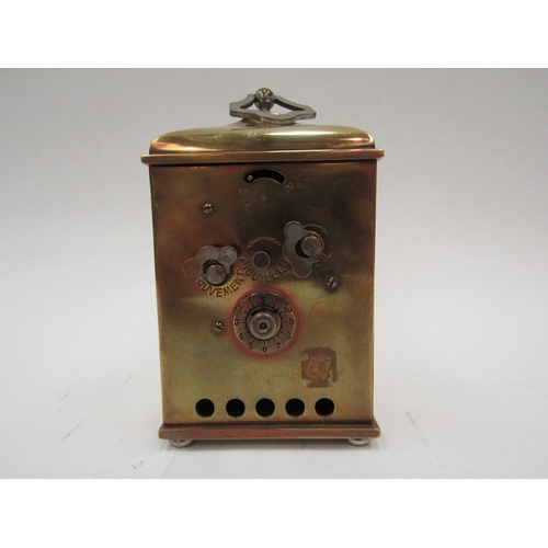 1323 - A brass carriage clock with Arabic chapter ring. Raised on ball feet   (R) £20