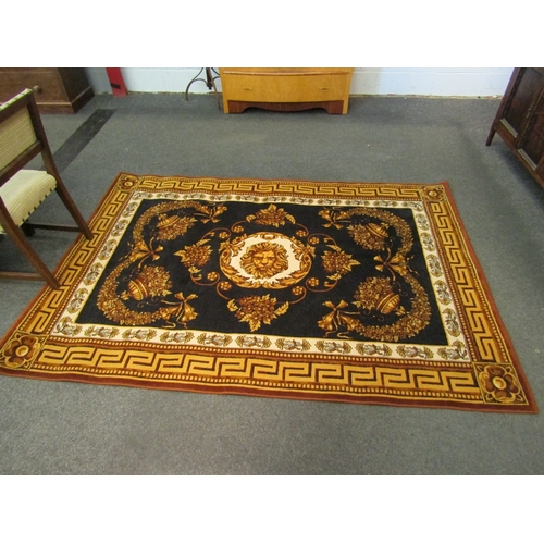 1474 - A large wool rug, black ground with gold and brown floral decoration and a Greek key border, 236cm x... 