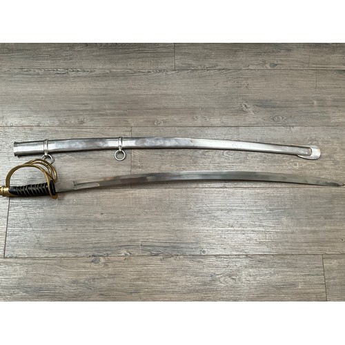 5429 - A replica cavalry sabre with brass three bar hilt, black leather and wired grip, steel scabbard