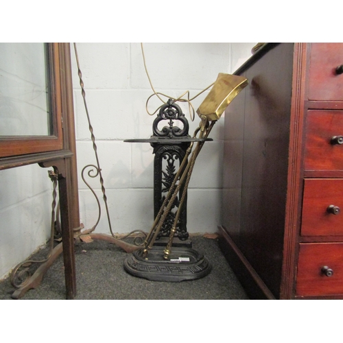 1006 - A Victorian cast iron stick stand, a three piece set of brass fire irons and a pair of 19th Century ... 