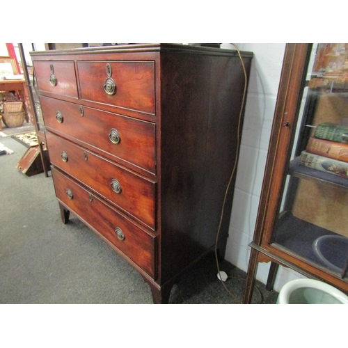 1016 - A George III mahogany straight front chest of two short over three long drawers with brass handles, ... 