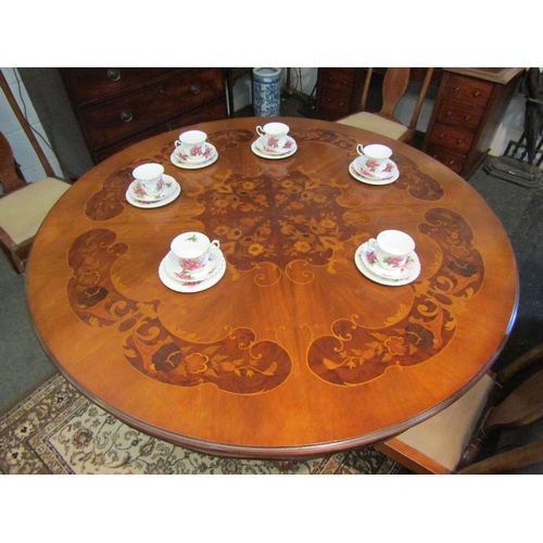 1021 - A Victorian mahogany circular breakfast table with scalloped apron and ornate column to a carved qua... 