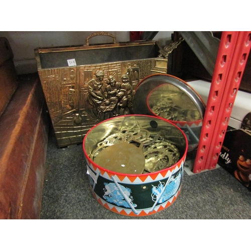 1051 - A tin of horse brasses, a box of metal wares and a brass magazine rack