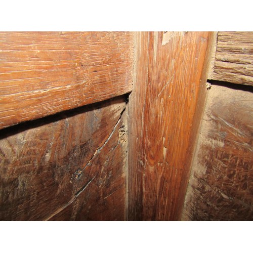 3 - A 17th Century pegged oak coffer the split hinge top over a four panel base on stile feet, 108cm wid... 