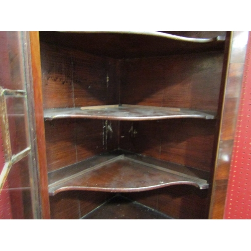 56 - A Georgian flame mahogany corner cabinet with glazed door and shaped shelved interior with key, 112c... 