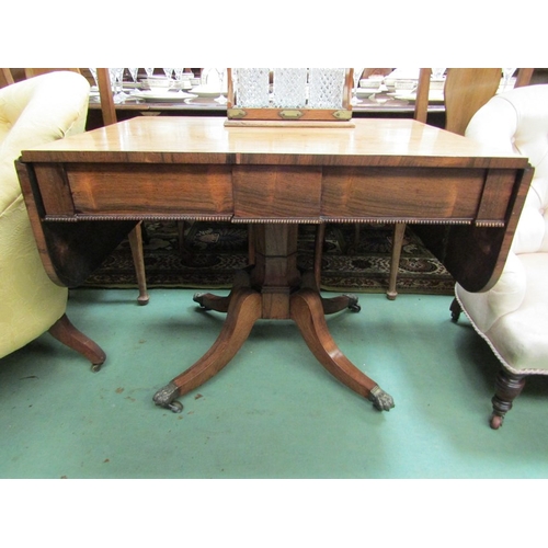 166 - A Regency rosewood sofa table with facet stem over quatreform base