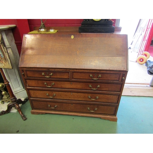 156 - A country house oak bureau with mahogany crossbanding the fitted interior and fall with key over two... 