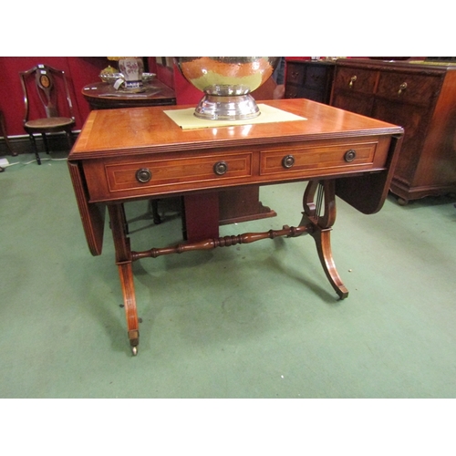 165 - A George III revival sofa table the rising leaves over two frieze drawers on a lyre end base and out... 