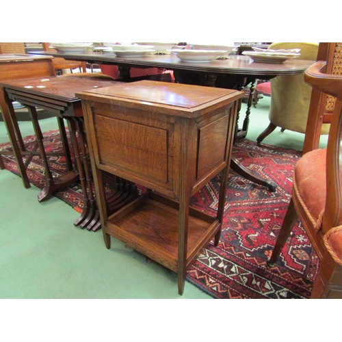 188 - Circa 1920 a two tiered oak work box, the hinged lid over square tapering legs joined by a galleried... 