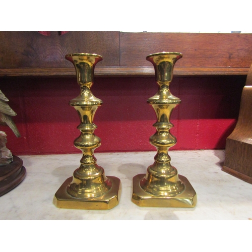 145 - A pair of 19th Century brass ejector candlesticks, 23cm high