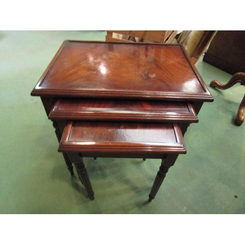 158 - A nest of three mahogany tables with fluted legs