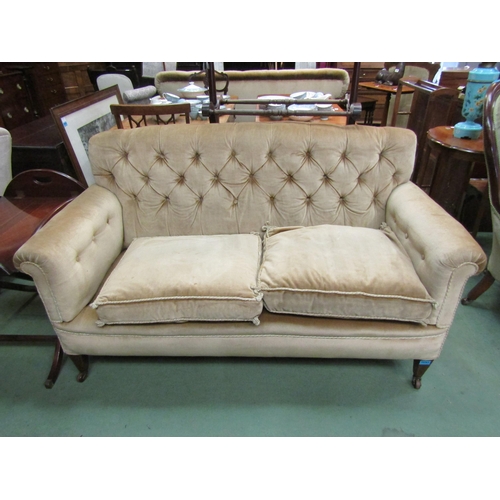 173 - A late Victorian button back two seater sofa, the scroll arms over square tapering mahogany feet wit... 